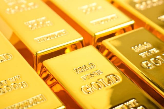 Gold Falls As Dollar Holds Firm On Fed Rate-Hike Expectations
